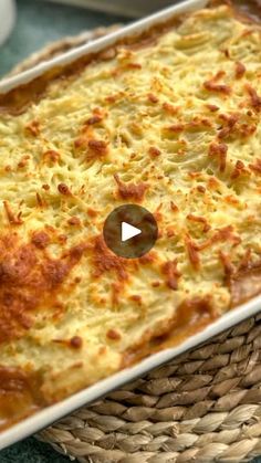 a casserole dish with cheese on top in a wicker basket