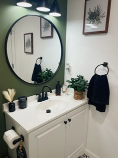 a bathroom with a large round mirror above the sink