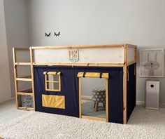 a child's play house made out of wood and canvas