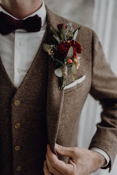 a man wearing a brown suit and bow tie