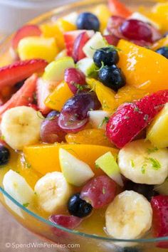 a fruit salad is shown in a glass bowl