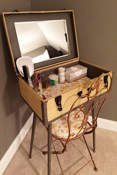 an old vanity table with a mirror on top and other items sitting in the drawer