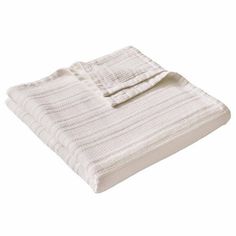 a white blanket folded on top of a bed