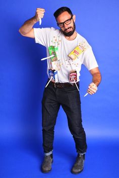 a man is posing with his hands on his hips and holding candy in one hand