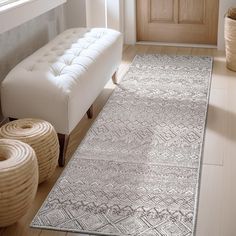 a living room with a white couch and rug on the floor