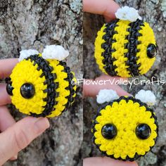 three small yellow and black crocheted balls with eyes on them sitting in front of a tree