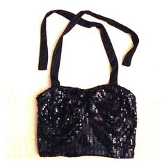 Black sequin halter top Super cute! Wet Seal halter top. The front has in padded bra cups and completely covered with sequins. Also has a sequin bow detail. Hard to see in pics but it's right between the tatas :) The back is stretchy to keep it from falling down. Ties around the neck. Wet Seal Tops Crop Tops Sequin Halter Top, Sequin Halter, Sequin Bow, Padded Bra, Wet Seal, Falling Down, Bra Cups, Black Sequins, Bow Detail