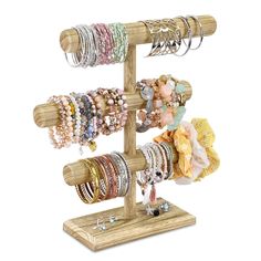 a wooden stand with bracelets and rings on it