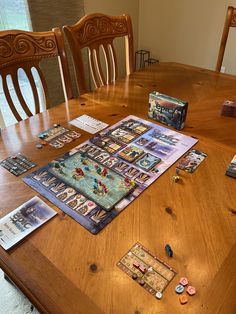 a wooden table topped with games and cards