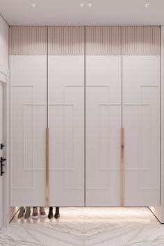 an empty room with white closets and marble flooring in front of the doors