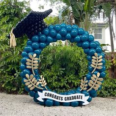 a wreath made out of balloons with congratulations written on it