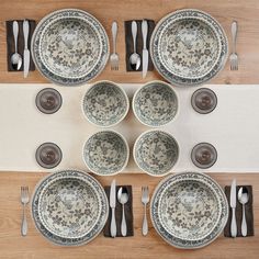 an overhead view of a table set with plates and silverware