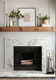 a fireplace with white marble surround and shelves on the mantle, along with potted plants