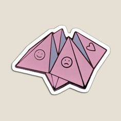 two pink stickers with faces on them, one in the shape of an origami