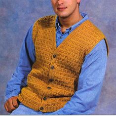 a man wearing a sweater vest and blue shirt