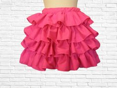 This fun, flirty skirt features four (4) layers of ruffles and an elastic waistband for comfort. The vibrant pink color is sure to draw attention and have all eyes on you. This custom skirt can be dressed up with a pair of heels or dressed down with a pair of flats or cute sneakers. Available in sizes XS - 4XL (PLEASE view size chart provided before placing your order) Additional colors available (see drop down tab for options) For large quantity orders, please convo me first so we can set everything up for you. There are no refunds for my custom items, merchandise credit or even exchange only! Stretch Ruffled Skort For Parties, Stretch Skort With Ruffles For Party, Tiered Cotton Mini Skirt For Party, Stretch Skort With Ruffles, Stretch Full Skirt With Ruffles, Party Cotton Tiered Mini Skirt, Stretch Ruffled Tiered Skort, Tiered Ruffle Skort With Stretch, Tiered Ruffle Stretch Skort