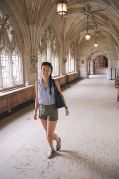 a woman is walking in an old building