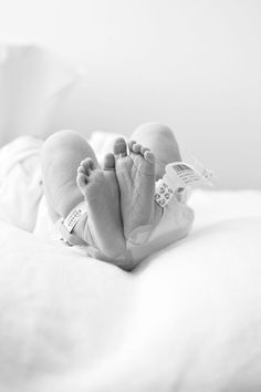 a black and white photo of a baby's feet