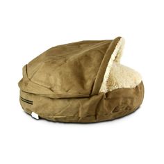 a dog bed with a hood on it's back and a white background behind it