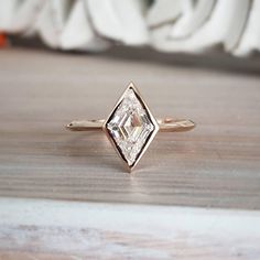 a diamond ring sitting on top of a wooden table