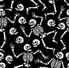 a black and white skeleton pattern with lots of skulls on it's back ground