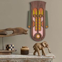 an elephant figurine stands next to a wooden clock