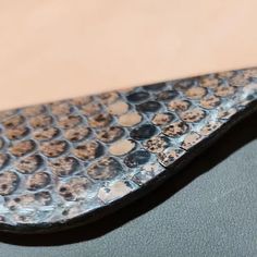 a close up view of a metal object on a surface with holes in the middle