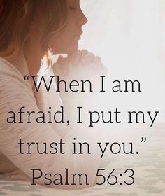 a woman sitting on top of a bed next to a window with the words, when i am afraid, i put my trust in you