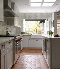 a kitchen with white cabinets and tile flooring is pictured in this image from the inside