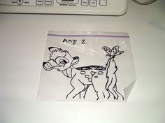 a drawing of two giraffes on a piece of paper next to a microwave