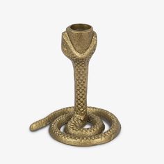 a gold snake - like candle holder on a white background