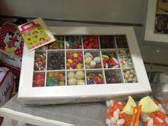 a tray filled with assorted candies on top of a table