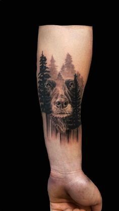 a man's arm with a dog and trees on it