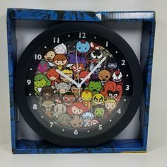 a clock with many cartoon characters on it in a blue and black box against a white background