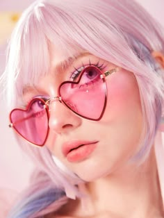 a woman with pink hair and heart shaped glasses