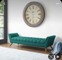 a living room with a couch and clock on the wall