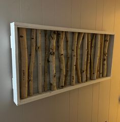 a wooden shelf with branches hanging on the wall