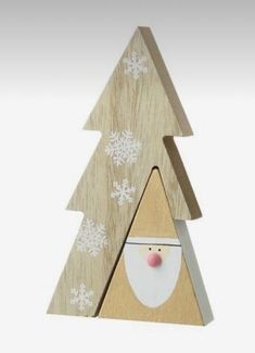 a wooden christmas tree with a santa clause on it's face and snowflakes