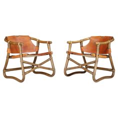 a pair of wooden rocking chairs with leather seats