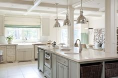 a kitchen with white cabinets and an island