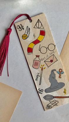 a bookmark with harry potter stickers on it next to an envelope and some other items