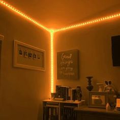 a room that has some lights on the ceiling and bookshelves in front of it