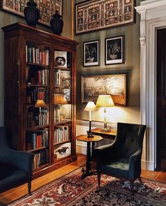 a living room filled with furniture and pictures on the wall