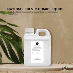 a gallon of liquid sitting on top of a table next to a plant with the caption natural fluivic humic liquid