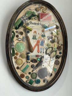 a clock with buttons and other things on it's face hanging from the wall