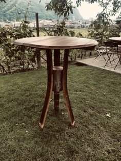 a wooden table sitting on top of a lush green field