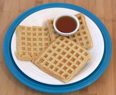 two waffles on a plate with a cup of coffee