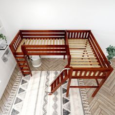 two wooden bunk beds sitting next to each other on top of a white and wood floor