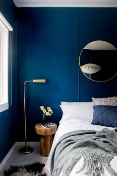 a bedroom with blue walls and white bedding in the corner is featured on instagram