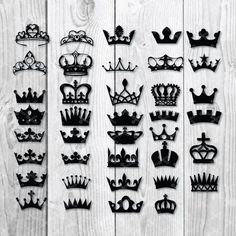 black crowns are arranged on a white wooden surface